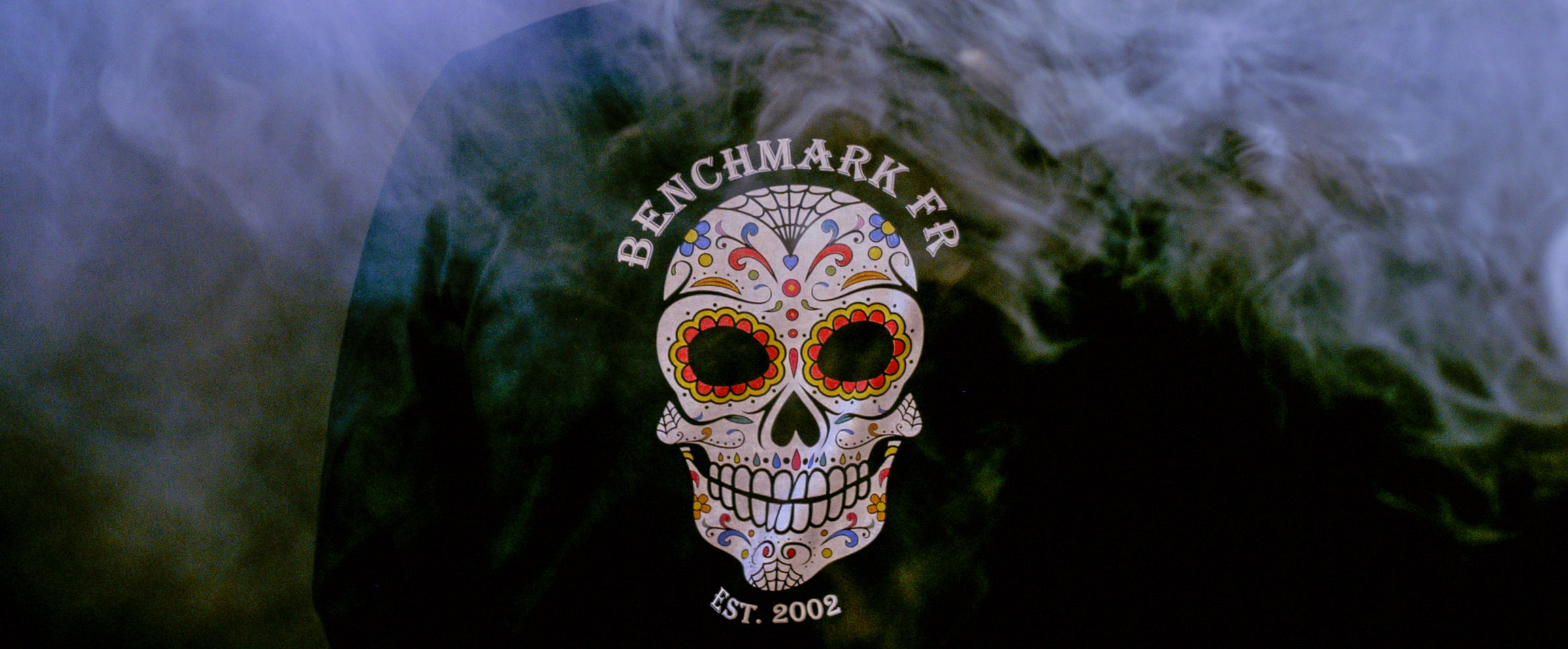 Skull design with 'Benchmark FR' logo on a dark background